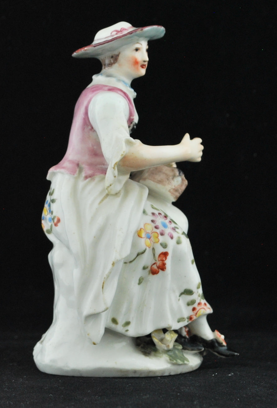 Columbine, playing her hurdy-gurdy