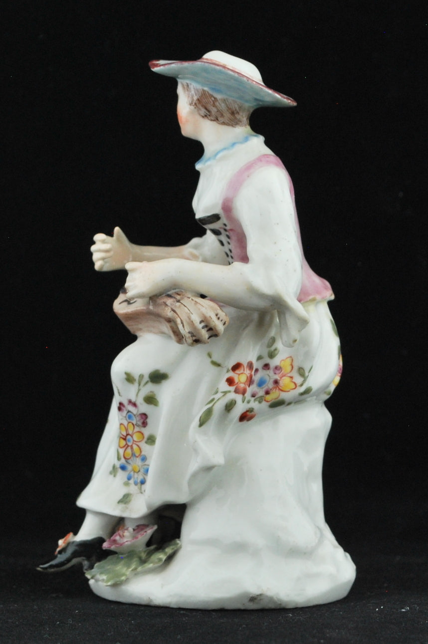 Columbine, playing her hurdy-gurdy