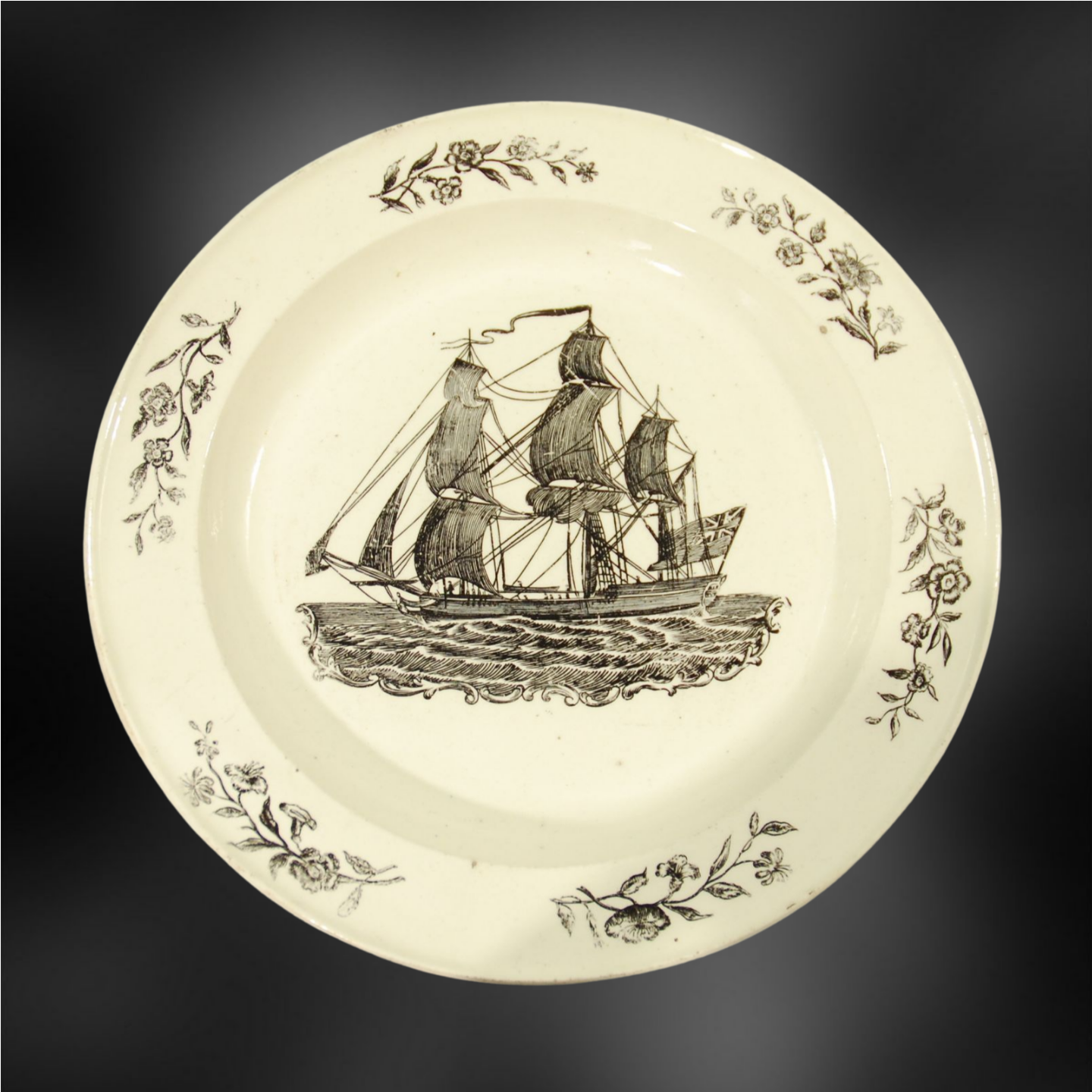Plate: Ship with furled mainsail, flying British flag.